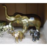 A large brass elephant - sold with two smaller brass elephants