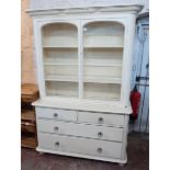 A 4' 5 1/2" Cornish style painted wood two part dresser with moulded bobbin cornice to glazed top