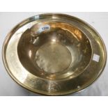 A 12" diameter Chinese brass-nickel bowl with engraved landscape within a bat, cloud and shou border