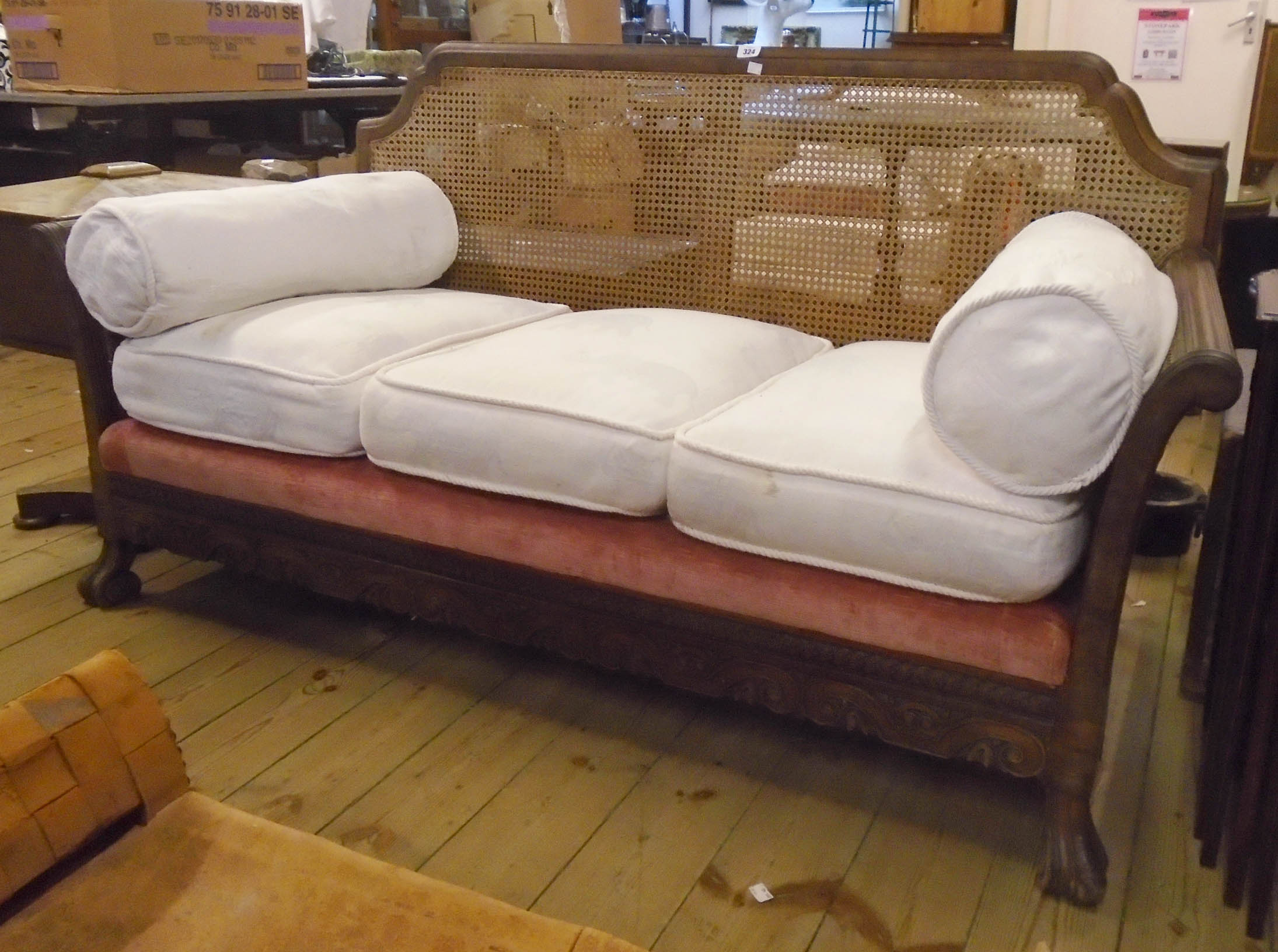 A 1920's walnut framed three piece Bergere suite, comprising 5' 6" three seater settee and pair of