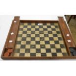 An old pub checkers board with wall hanging hook and flanking compartments containing a complete set