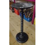 A late Victorian ebonised aspidistra stand with barley twist pillar and iron loaded circular base