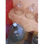 A carboy and two glass cloches