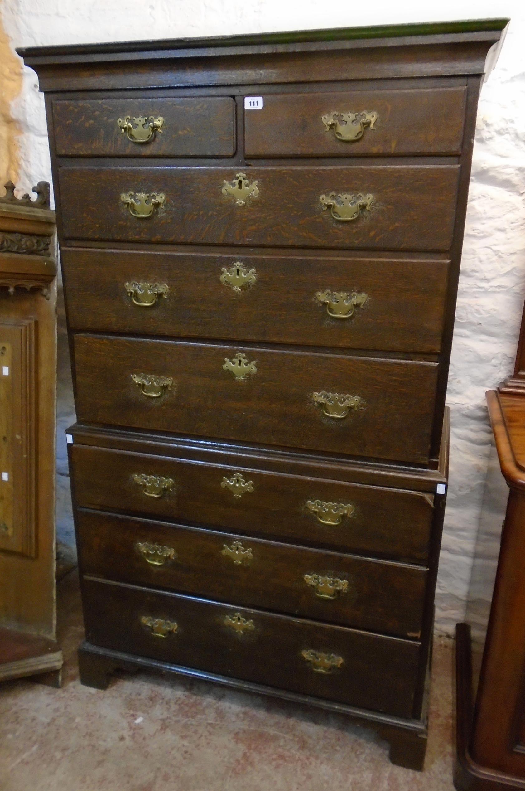 A 3' 4" 19th Century quarter sawn oak chest on chest of two short and six long graduated drawers,