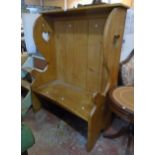 A 3' 11" waxed pine wing back settle with heart pierced sides and solid seat