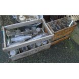 Two vintage wooden crates containing clear glass bottles