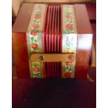 A boxed 20th Century German Bandmaster concertina with red and printed decoration
