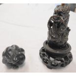 An early 20th Century carved wood netsuke in the form of a dragon holding a flaming pearl - sold