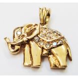 An unmarked high carat yellow metal diamond encrusted elephant pattern pendant