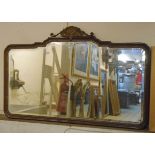 A Georgian style wall mirror with walnut and parcel gilt frame, shell motif to top and shaped