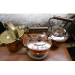 Two copper kettles, a brass hot water jug and a heavy brass trivet