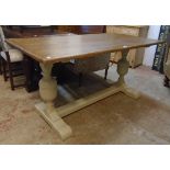 A 5' polished oak topped refectory table, set on painted flanking bulbous turned supports with