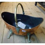An elliptical swing handled copper coal bucket with lion mask bosses and claw feet