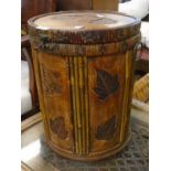 A 12 1/2" diameter decorative lift-top storage barrel with inset leaves, bamboo and cane binding
