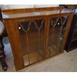 A 3' 7" mid 20th Century walnut veneered display cabinet with glass shelves enclosed by a pair of