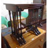 A nest of three reproduction mahogany and strung tea tables, set on slender ring turned supports