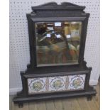 A 28" Edwardian cast iron framed overmantel mirror with bevelled plate and three decorative inset