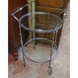A modern retro style plated metal two tier tea trolley with glass surfaces and pierced galleries
