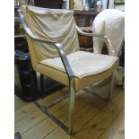 A Vintage brushed bent steel framed elbow chair with beige leather upholstery