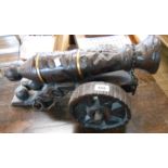 A carved wood model of a cannon