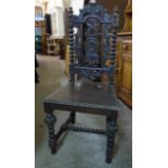 An ornate carved oak framed standard dining chair - sold with a two tier basket and wrought iron