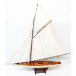 A 39" long wooden model of a gaff-rigged cutter on stand