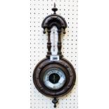 A late Victorian walnut framed aneroid barometer/thermometer with printed ceramic scale and
