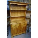 A 3' 1" modern polished pine two part dresser with two shelf open plate rack, over a base with two