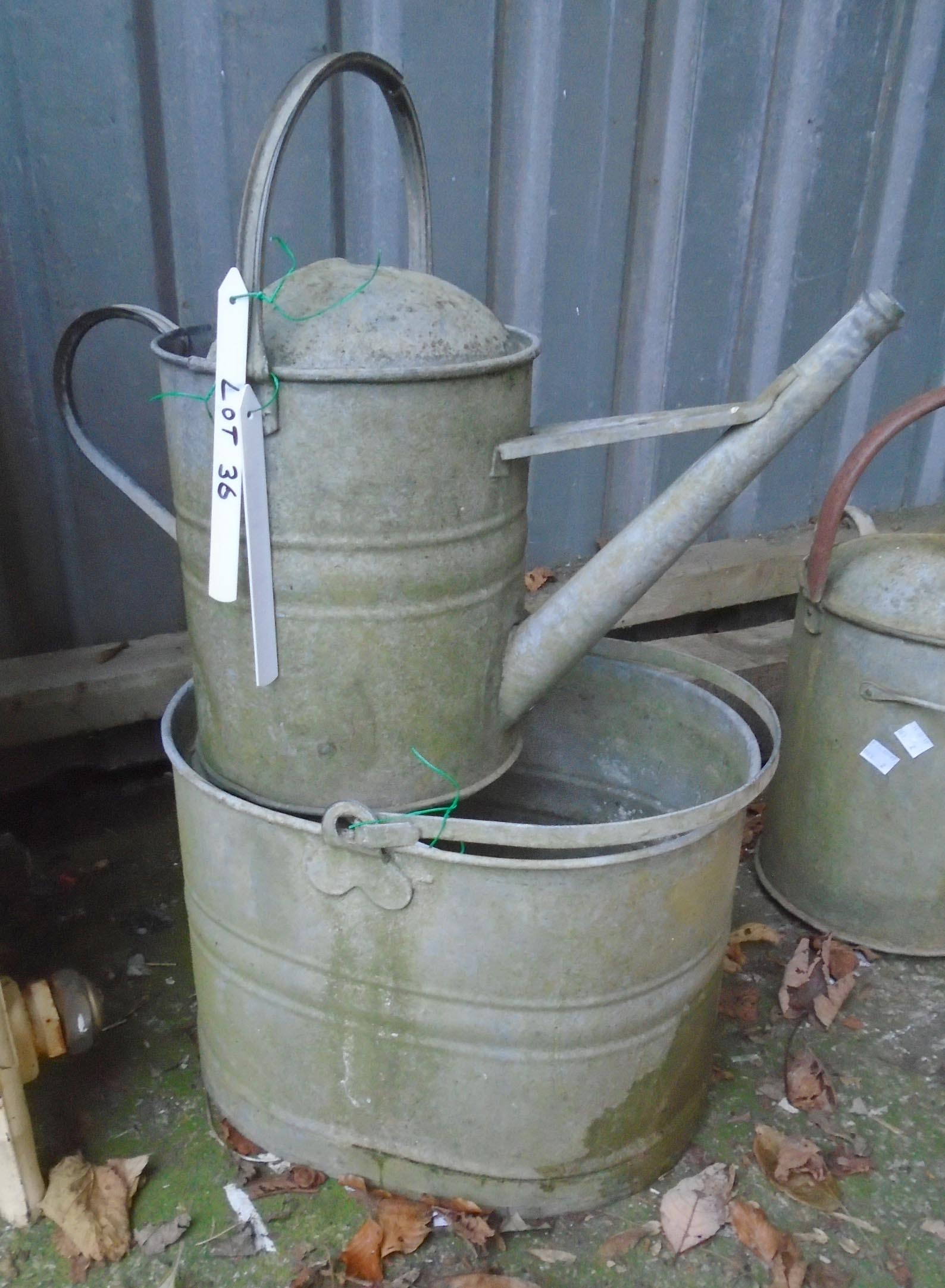 A galvanized mop bucket and watering can