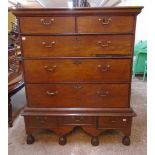 A 3' 4" antique continental stained oak chest of two short and three long graduated drawers, set