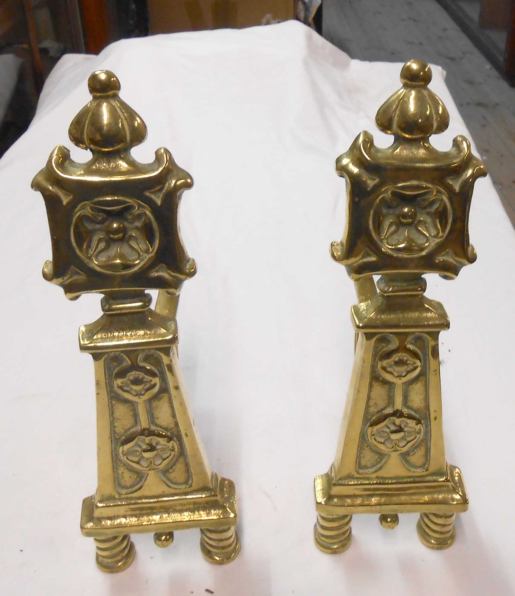 A pair of cast brass andirons with English Rose decoration