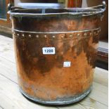 A copper coal bucket with riveted decoration and brass handle