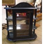 An 18" ebonised wood wall hanging display cabinet with central glazed panel door and flanking