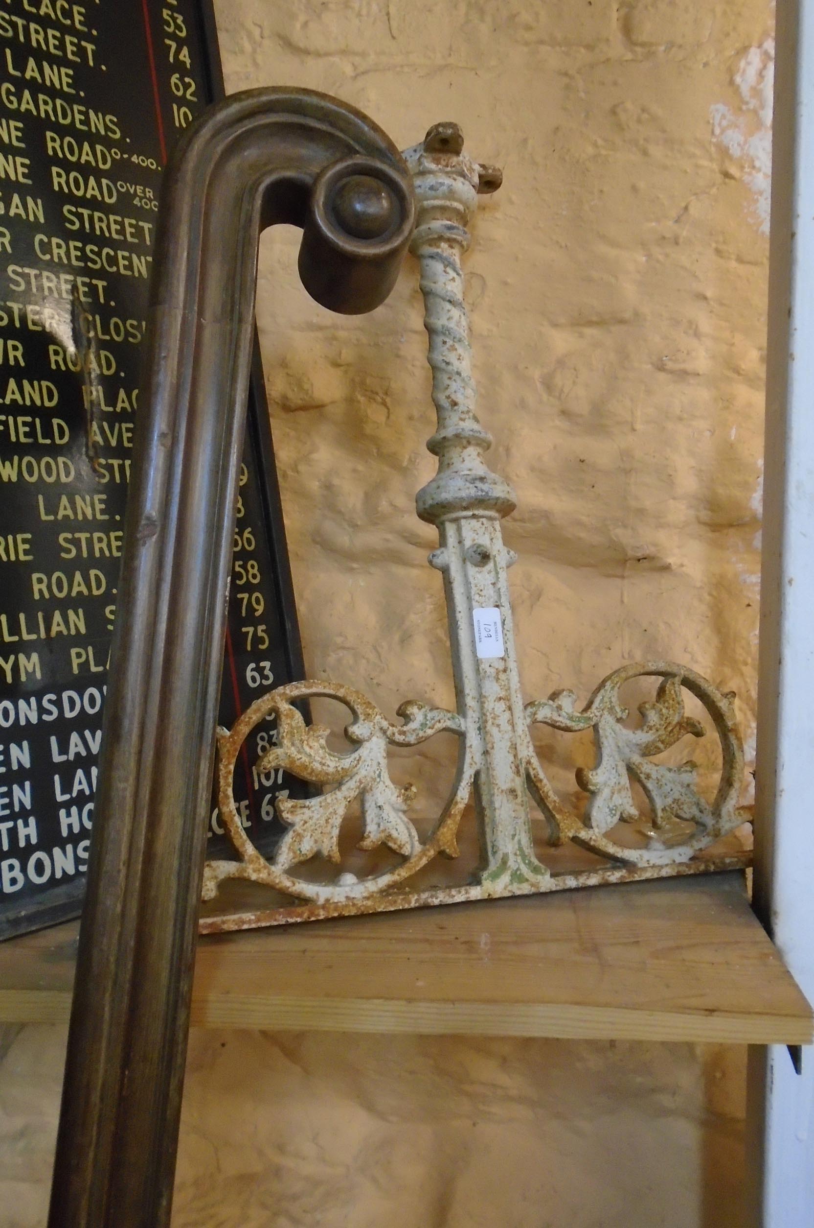 A 6' 6" mahogany altar rail with scroll ends and three cast iron supports