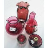 A collection of cranberry glassware including two jugs, vase, etc.