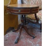 A 23 1/2" diameter reproduction mahogany drum table with leather inset top and three frieze drawers,
