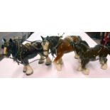 Three ceramic figures of cart horses, two harnessed up