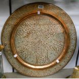A 22 3/4" diameter circular copper tray with all-over embossed decoration