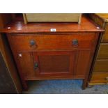 A 30" early 20th Century later stained oak pot cupboard with long drawer over, set on square legs