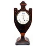 An Edwardian mahogany and strung urn pattern timepiece with French eight day movement