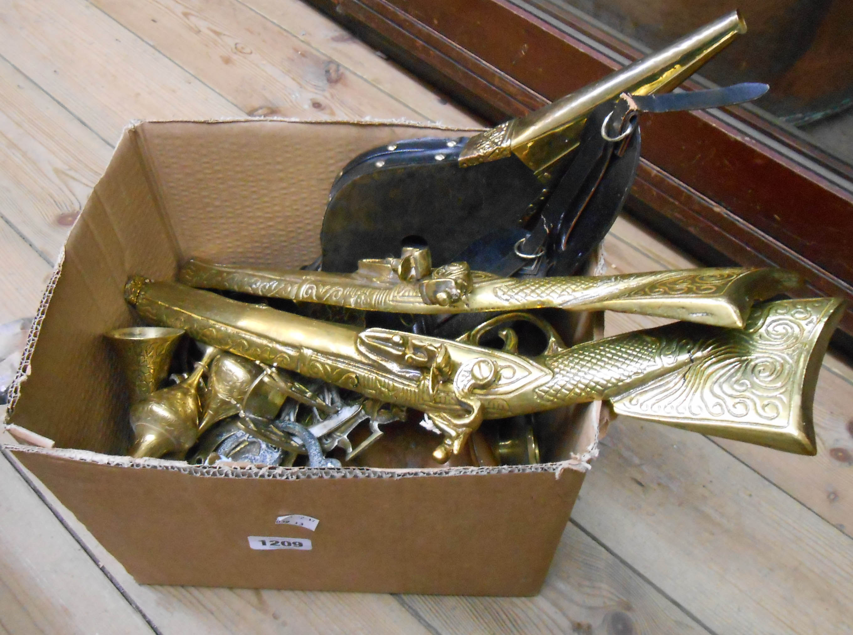 A box containing a quantity of brassware including vases, candlesticks, bellows, etc.