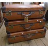 A set of three graduated fibreboard suitcases with leather corners and handles - by BCM Orient