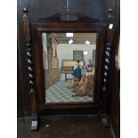 An oak framed fire screen with Vermeer style wool work panel and flanking barley twist supports -
