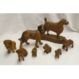 A collection of carved wooden St. Bernard and other dogs