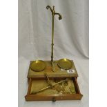 An antique set of brass jeweller's balance scales with integral box/stand and weights including