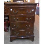 A 19" reproduction mahogany and cross banded bachelor's style bedside chest with serpentine front,