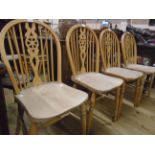 A set of four 20th Century wheel back kitchen chairs with solid elm seats, set on turned supports