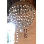 A basket pendant ceiling light with glass dome and finial and faceted glass lustres