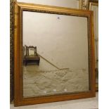 A modern gilt framed bevelled oblong wall mirror with antiqued finish