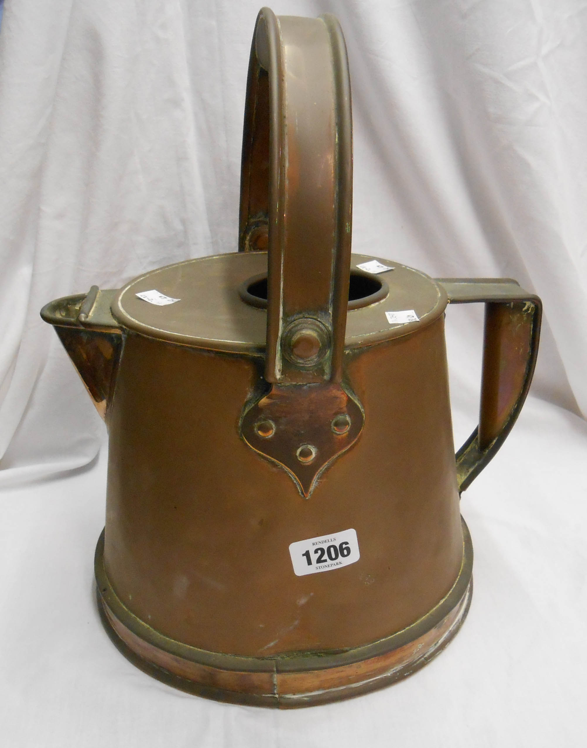 A copper hot water jug with swing and fixed handles